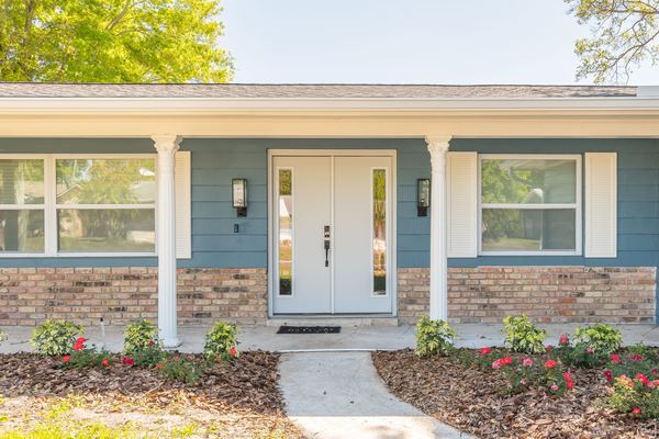 Front entrance with columns and brick facade