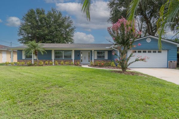 Front of Holden Lake House with lush green lawn
